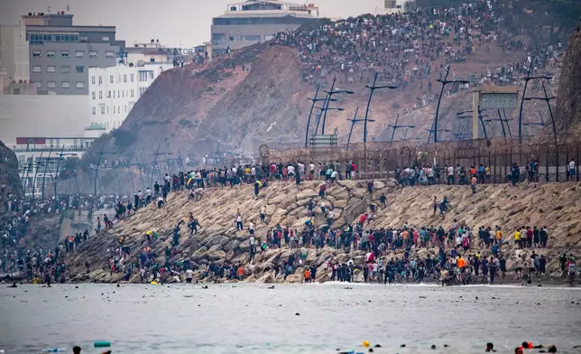 Migrants return to Morocco from the Spanish enclave of Ceuta, Friday, July 31, 2026. (AP Photo/Antonio Sempere)