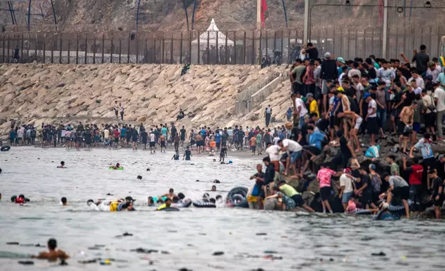 Migrants return to Morocco from the Spanish enclave of Ceuta, Friday, July 31, 2026. (AP Photo/Antonio Sempere)