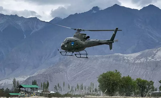 A Pakistan army helicopter carrying bodies of climbers, that were recovered from Broad Peak nearly a week after an avalanche swept away a 10-member international expedition, prepares to land at a military base in Skardu, in northern Pakistan, Thursday, Aug. 6, 2026. (AP Photo/ M.H. Balti)