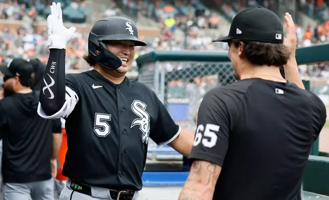 Chicago White Sox's Munetaka Murakami (5) celebrates with Davis Martin (65) after hitting a two-run home run against the Detroit Tigers during the seventh inning of a baseball game Sunday, Aug. 16, 2026, in Detroit. (AP Photo/Duane Burleson)