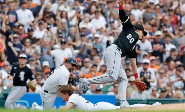 Chicago White Sox third baseman Miguel Vargas (20) fails to reach Detroit Tigers' Brett Callahan to make the tag, as Callahan slides into third base with a triple during the second inning of a baseball game Sunday, Aug. 16, 2026, in Detroit. (AP Photo/Duane Burleson)