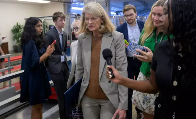 Sen. Lisa Murkowski, R-Alaska, talks with reporters as she walks through the Senate subway at the U.S. Capitol during a vote, Friday, August 7, 2026 in Washington. (AP Photo/Rod Lamkey, Jr.)