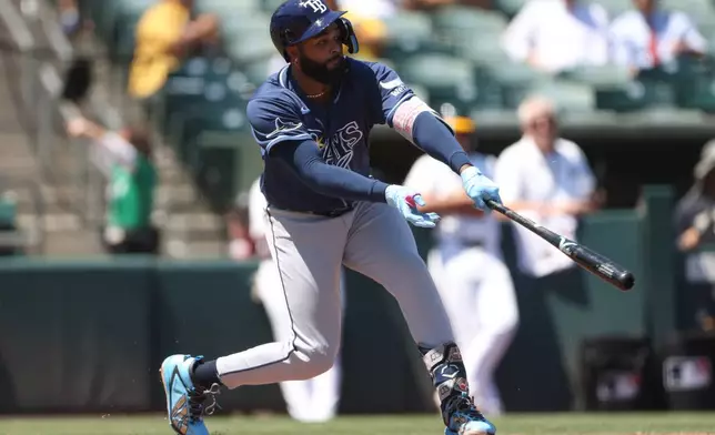 Tampa Bay Rays' Junior Caminero hits an RBI single during the fourth inning of a baseball game against the Athletics Wednesday, Aug. 12, 2026, in West Sacramento, Calif. (AP Photo/Scott Marshall)