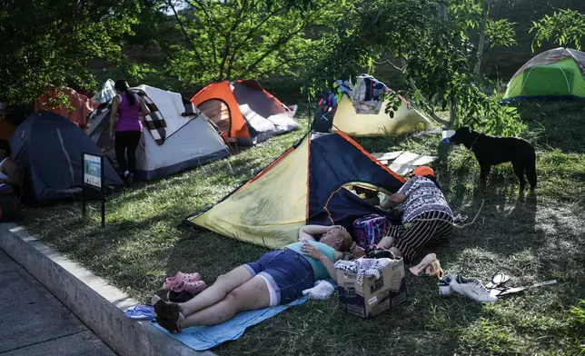 People evacuated from their earthquake-damaged homes camp in a park three days after a quake hit Cali, Colombia, Thursday, Aug. 13, 2026. (AP Photo/Ivan Valencia)