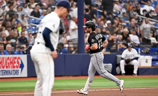 Chicago White Sox's Andrew Benintendi (23) rounds the bases after hitting a home run off Tampa Bay Rays pitcher Griffin Jax, left, during the fourth inning of a baseball game Sunday, Aug. 2, 2026, in St. Petersburg, Fla. (AP Photo/Jason Behnken)