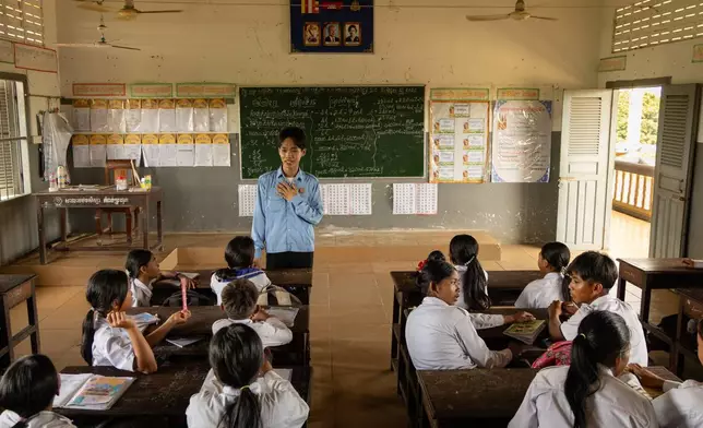 A teacher addresses students at a school in one of the floating villages of Cambodia's Tonle Sap Lake on Monday, June 29, 2026. (AP Photo/Anton L. Delgado)