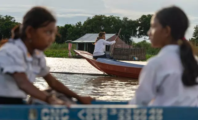 Students board school boats to return to their homes in a floating village on Cambodia's Tonle Sap Lake on Monday, June 29, 2026. (AP Photo/Anton L. Delgado)