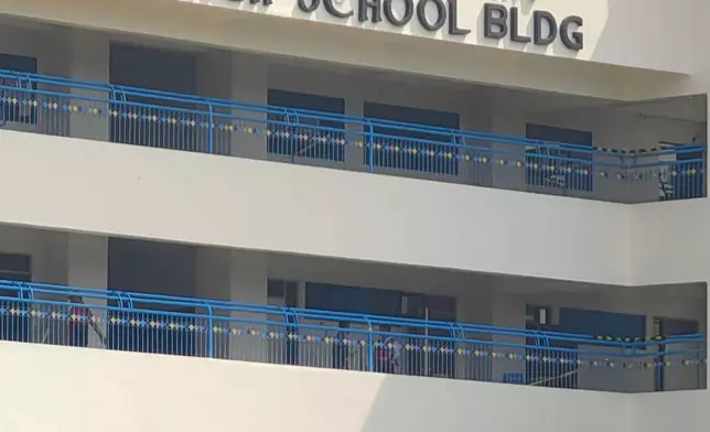Police and security guards secure a junior high school building on the Ateneo de Zamboanga University campus following a shooting incident in Zamboanga, southern Philippines Tuesday, Aug. 18, 2026. (AP Photo)