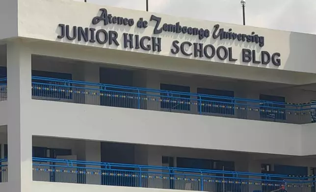 A guard secures an area at the junior high school building on the Ateneo de Zamboanga University campus following a shooting incident in Zamboanga, southern Philippines Tuesday, Aug. 18, 2026. (AP Photo)