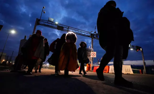 FILE - Refugees fleeing the conflict in neighboring Ukraine arrive to in Przemysl, Poland, Sunday, Feb. 27, 2022. (AP Photo/Petr David Josek, File)