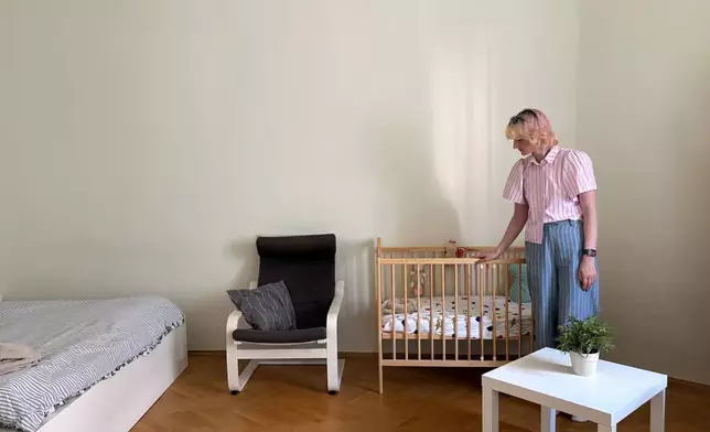 Nastya Podorozhnya stands in one of the two bedrooms of the shelter which the Martynka non-profit is running in Krakow, Poland, Thursday, July 2, 2026. (AP Photo/Claudia Ciobanu)