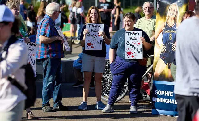 People rally to support Indiana Fever guard Sophie Cunningham after her comments on transgender athletes in women's sports before a WNBA basketball game between the Portland Fire and the Indiana Fever in Portland, Ore., Friday, July 31, 2026. (AP Photo/Craig Mitchelldyer)