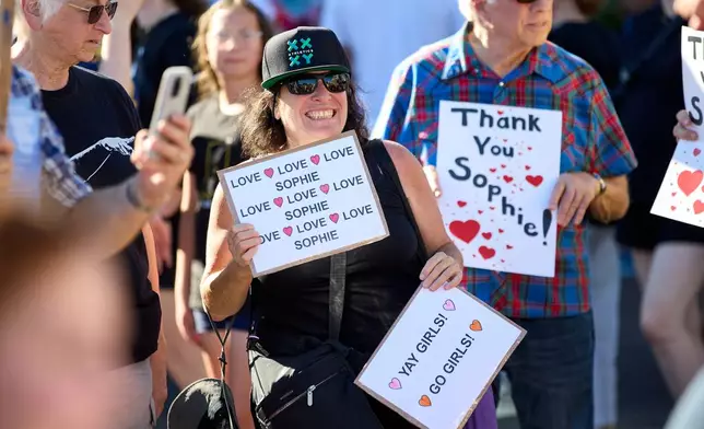 People rally to support Indiana Fever guard Sophie Cunningham after her comments on transgender athletes in women's sports before a WNBA basketball game between the Portland Fire and the Indiana Fever in Portland, Ore., Friday, July 31, 2026. (AP Photo/Craig Mitchelldyer)