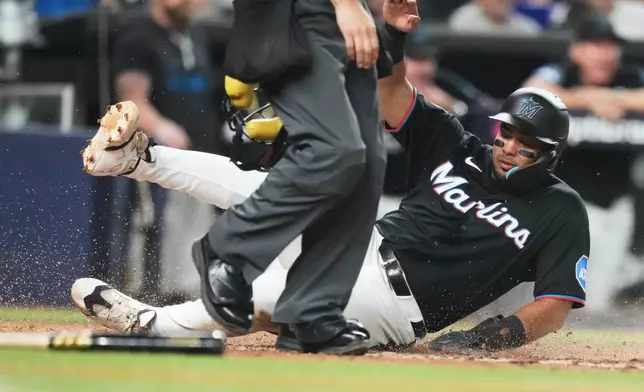 Miami Marlins' Leo Jimenez scores on a sacrifice fly hit by Brian Navarreto during the fifth inning of a baseball game against the Boston Red Sox, Tuesday, Aug. 25, 2026, in Miami. (AP Photo/Lynne Sladky)