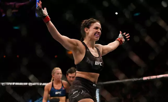 FILE - Mackenzie Dern, from the United States, celebrates after defeating countrywoman Amanda Cooper during their UFC women's strawweight mixed martial arts bout in Rio de Janeiro, Brazil, early Sunday, May 13, 2018. (AP Photo/Leo Correa, file)