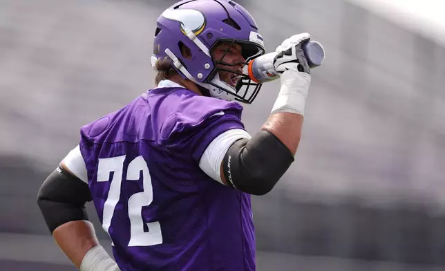 Minnesota Vikings tackle Ryan Van Demark (72) hydrates during the team's NFL football training camp Wednesday, July 29, 2026, in Eagan, Minn. (AP Photo/Abbie Parr)