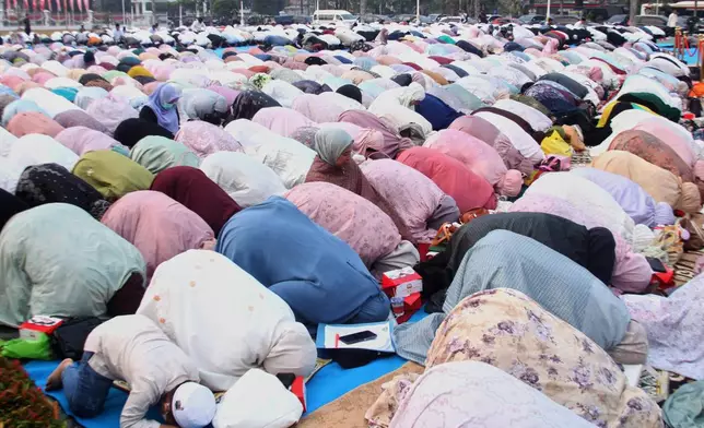 Indonesian Muslims perform a prayer requesting for rain following wildfires that burn through peatlands in several regions in Sumatra and Kalimantan Island, in Palembang, South Sumatra, Indonesia, Tuesday, Aug. 25, 2026. (AP Photo/Muhammad Fajri)