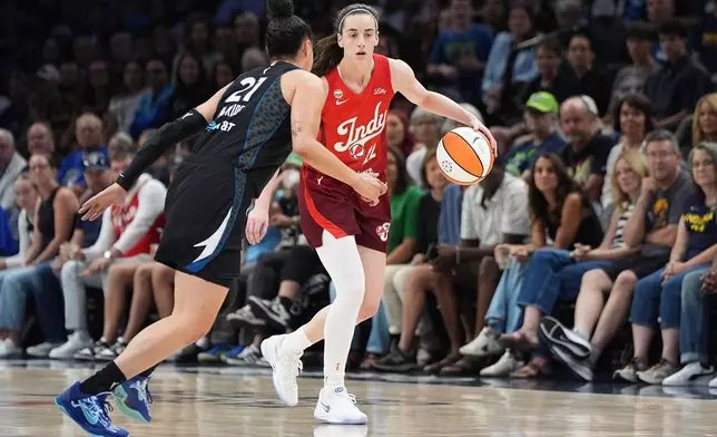 Indiana Fever guard Caitlin Clark, right,dribbles downcourt as Minnesota Lynx guard Kayla McBride (21) defends during the first half of a WNBA basketball game Sunday, Aug. 2, 2026, in Minneapolis. (AP Photo/Abbie Parr)