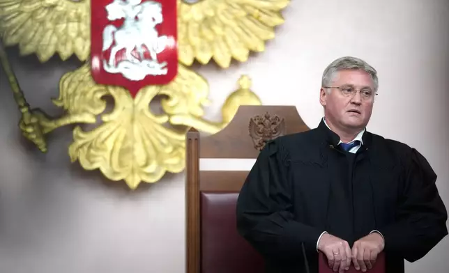 Judge Vyacheslav Kirillov pauses while reading the court decision during a hearing on a lawsuit to bar the Yabloko party from the upcoming parliamentary elections, at the Russia's Supreme Court, in Moscow, Monday, Aug. 10, 2026. (AP Photo/Pavel Bednyakov)