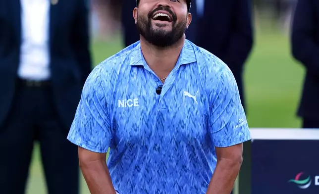 J. J. Spaun of United States lifts the trophy after winning the PGA Championship at Wentworth Golf Club in Virginia Water, England, Sunday Sept. 20, 2026. (Adam Davy/PA via AP)