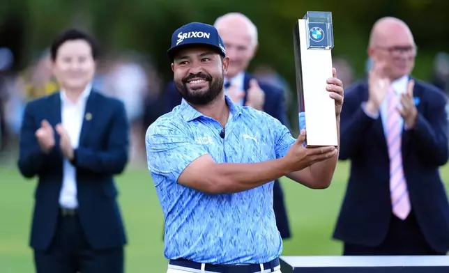 J. J. Spaun of United States lifts the trophy after winning the PGA Championship at Wentworth Golf Club in Virginia Water, England, Sunday Sept. 20, 2026. (Adam Davy/PA via AP)