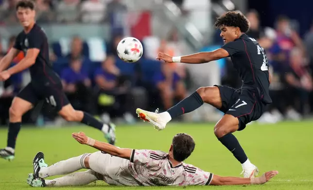United States' Mathis Albert, right, reaches for the ball over Chile's Iván Román during the second half of an international friendly soccer match Tuesday, Sept. 29, 2026, in St. Louis. (AP Photo/Jeff Roberson)