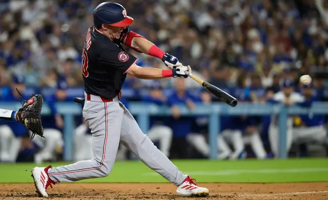Washington Nationals' Jacob Young hits an RBI single during the fourth inning of a baseball game against the Los Angeles Dodgers in Los Angeles, Sunday, Sept. 6, 2026. (AP Photo/Kyusung Gong)
