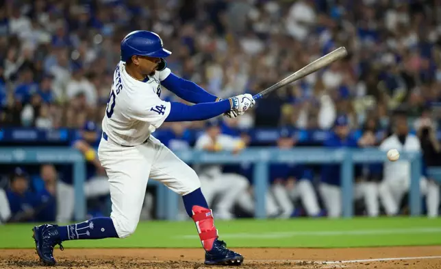Los Angeles Dodgers' Mookie Betts hits for an RBI groundout during the third inning of a baseball game against the Washington Nationals in Los Angeles, Sunday, Sept. 6, 2026. (AP Photo/Kyusung Gong)