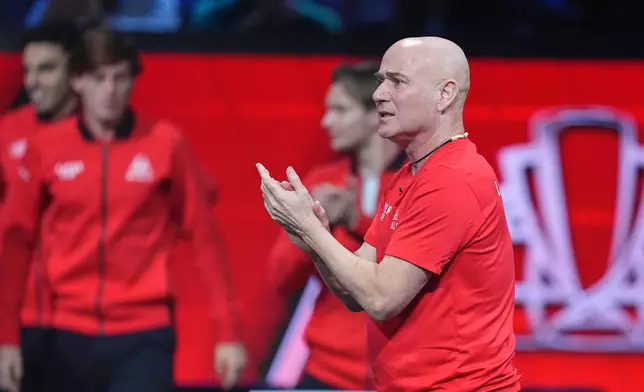Team World captain Andre Agassi applauds as he watches Team World's Taylor Fritz play Team Europe's Carlos Alcaraz in a Laver Cup tennis tournament match in London, Saturday, Sept. 26, 2026. (AP Photo/Maja Smiejkowska)