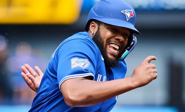 Toronto Blue Jays' Vladimir Guerrero Jr. (27) sprints in to score on a single by Alejandro Kirk (30), not shown, during first inning a baseball game against the Baltimore Orioles in Toronto, on Saturday, Sept. 12, 2026. (Sammy Kogan/The Canadian Press via AP)