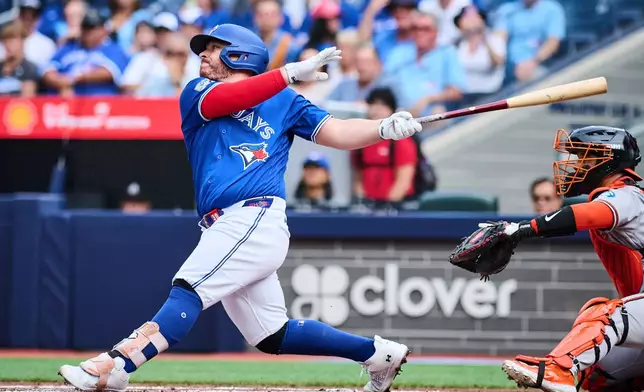 Toronto Blue Jays' Alejandro Kirk (30) hits an RBI single against the Baltimore Orioles during the first inning of a baseball game in Toronto, on Saturday, Sept. 12, 2026. (Sammy Kogan/The Canadian Press via AP)