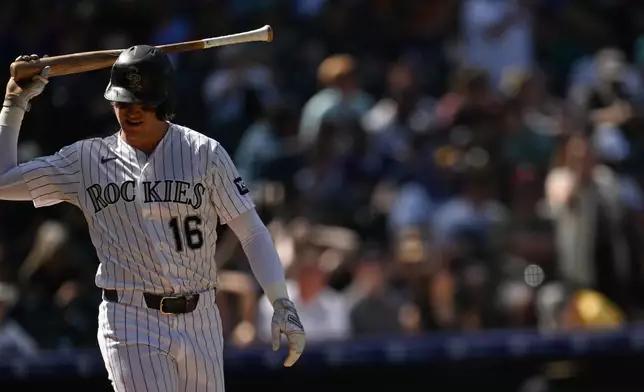 Colorado Rockies center fielder Cole Carrigg tosses his bat after striking out in the fourth inning against the Seattle Mariners during a baseball game Sunday, Sept. 20, 2026, in Denver. (AP Photo/RJ Sangosti)