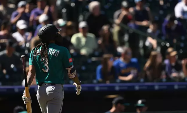 Seattle Mariners shortstop J.P. Crawford walks back to the dugout after striking out in the first inning against the Colorado Rockies during a baseball game Sunday, Sept. 20, 2026, in Denver. (AP Photo/RJ Sangosti)