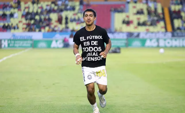 Leones Negros' Miguel Alvarado warms up wearing a T-shirt with a sign that reads, "Soccer is for everyone. Yes to promotion!", before a Mexican second-division soccer match against Atletico Morelia in Morelia, Michoacan state, Mexico, Saturday, Sept. 19, 2026. (AP Photo/Armando Solis)