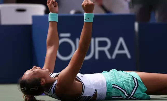 Zheng Qinwen, of China, celebrates after she won her match against Madison Keys, of the United States, during the third round of the U.S. Open tennis championships Saturday, Sept. 5, 2026, in New York. (AP Photo/Heather Khalifa)