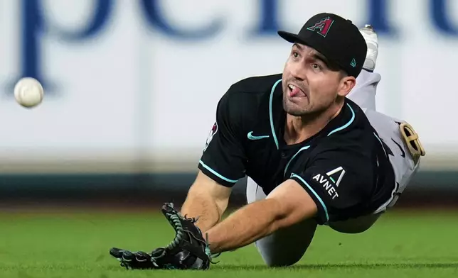 Arizona Diamondbacks center fielder Ryan Waldschmidt attempts to catch a line drive hit by Houston Astros' Isaac Paredes during the fifth inning of a baseball game Saturday, Sept. 5, 2026, in Houston. (AP Photo/Eric Christian Smith)