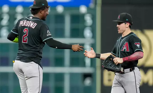 Arizona Diamondbacks' Geraldo Perdomo (2) and Corbin Carroll celebrates the team's win over the Houston Astros in a baseball game Saturday, Sept. 5, 2026, in Houston. (AP Photo/Eric Christian Smith)