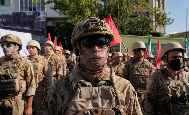 Armed personnel affiliated with Iran's Revolutionary Guard take part in the state-organized "Janfada," or "Sacrifice for Iran," military exercise in Tehran, Iran, Friday, Sept. 18, 2026. (AP Photo/Vahid Salemi)
