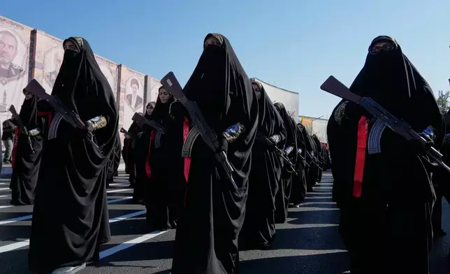 Women affiliated with Iran's Revolutionary Guard carry rifles as they march during the state-organized "Janfada," or "Sacrifice for Iran," military exercise in Tehran, Iran, Friday, Sept. 18, 2026. (AP Photo/Vahid Salemi)