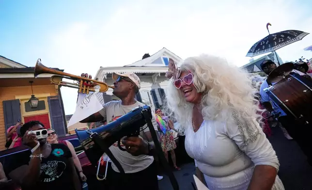 Members of the Krewe of Dolly lead a second line parade in commemoration of the life of Dolly Parton through the French Quarter Friday, Sept. 25, 2026, in New Orleans. (AP Photo/Gerald Herbert)