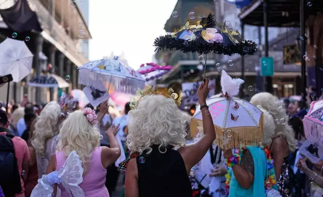 Members of the Krewe of Dolly lead a second line parade in commemoration of the life of Dolly Parton through the French Quarter Friday, Sept. 25, 2026, in New Orleans. (AP Photo/Gerald Herbert)