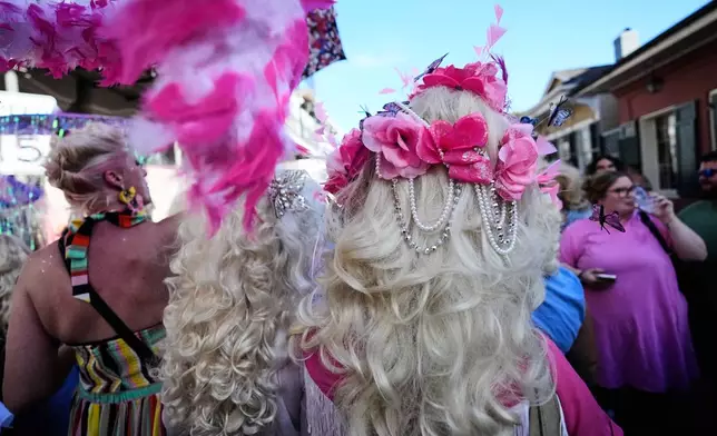 Members of the Krewe of Dolly lead a second line parade in commemoration of the life of Dolly Parton through the French Quarter Friday, Sept. 25, 2026, in New Orleans. (AP Photo/Gerald Herbert)