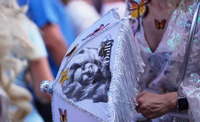 Members of the Krewe of Dolly lead a second line parade in commemoration of the life of Dolly Parton through the French Quarter Friday, Sept. 25, 2026, in New Orleans. (AP Photo/Gerald Herbert)