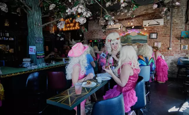 Participants in the Krewe of Dolly tribute congregate in the Rampart Treehouse Bar before a second line parade in commemoration of the life of Dolly Parton through the French Quarter Friday, Sept. 25, 2026, in New Orleans. (AP Photo/Gerald Herbert)