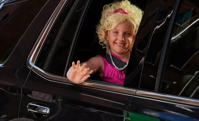 Maria Vantrease waves from a car as she wears a Dolly Parton costume Friday, Sept. 25, 2026, in Nashville, Tenn. during Dolly Parton Day honoring the late country music artist. (AP Photo/George Walker IV)