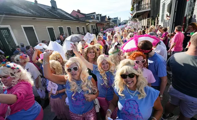 Members of the Krewe of Dolly lead a second line parade in commemoration of the life of Dolly Parton through the French Quarter Friday, Sept. 25, 2026, in New Orleans. (AP Photo/Gerald Herbert)