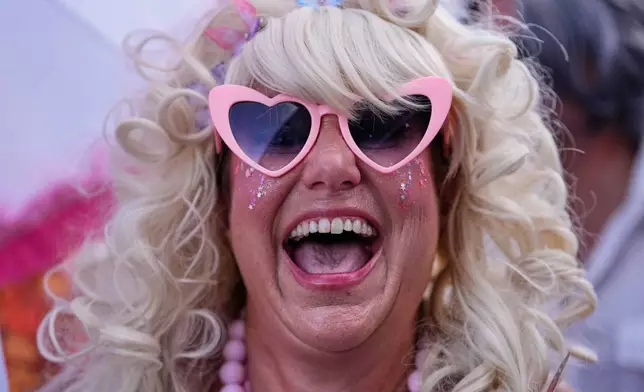 Members of the Krewe of Dolly lead a second line parade in commemoration of the life of Dolly Parton through the French Quarter Friday, Sept. 25, 2026, in New Orleans. (AP Photo/Gerald Herbert)