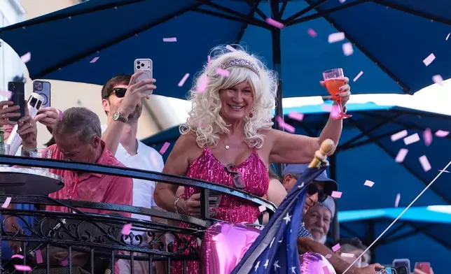Members of the Krewe of Dolly lead a second line parade in commemoration of the life of Dolly Parton through the French Quarter Friday, Sept. 25, 2026, in New Orleans. (AP Photo/Gerald Herbert)