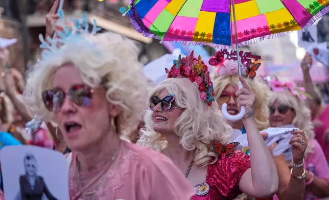 Members of the Krewe of Dolly lead a second line parade in commemoration of the life of Dolly Parton through the French Quarter Friday, Sept. 25, 2026, in New Orleans. (AP Photo/Gerald Herbert)