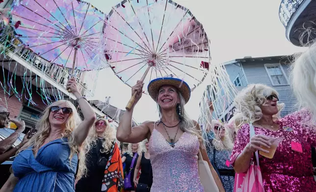Members of the Krewe of Dolly lead a second line parade in commemoration of the life of Dolly Parton through the French Quarter Friday, Sept. 25, 2026, in New Orleans. (AP Photo/Gerald Herbert)
